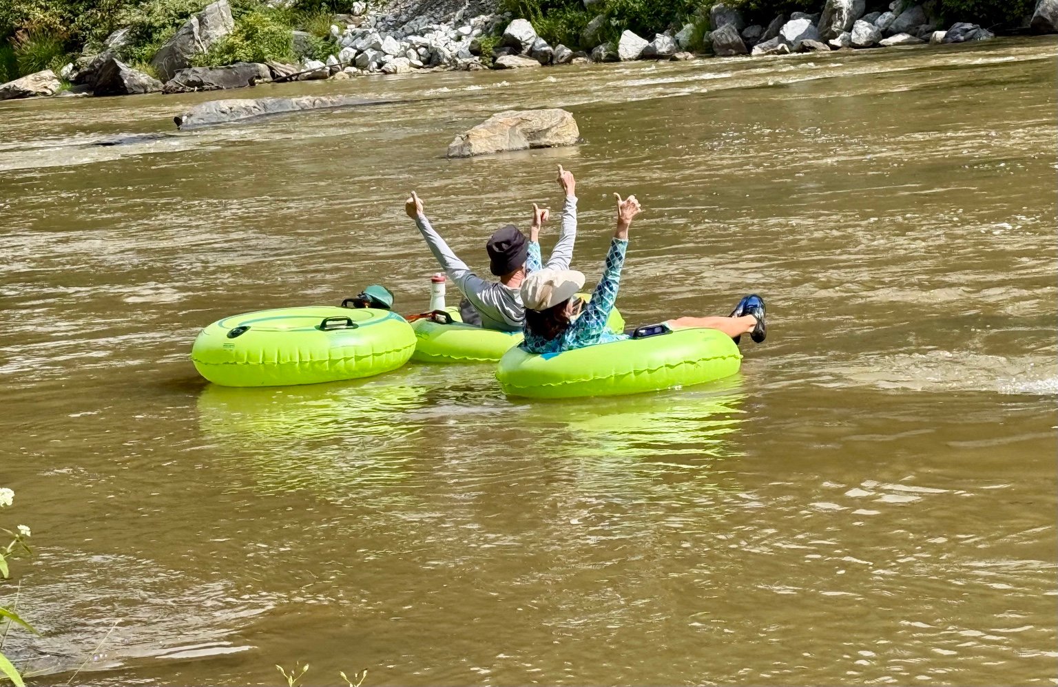 Couple relaxing in river tubes on the North Toe River near Bakersville, North Carolina
