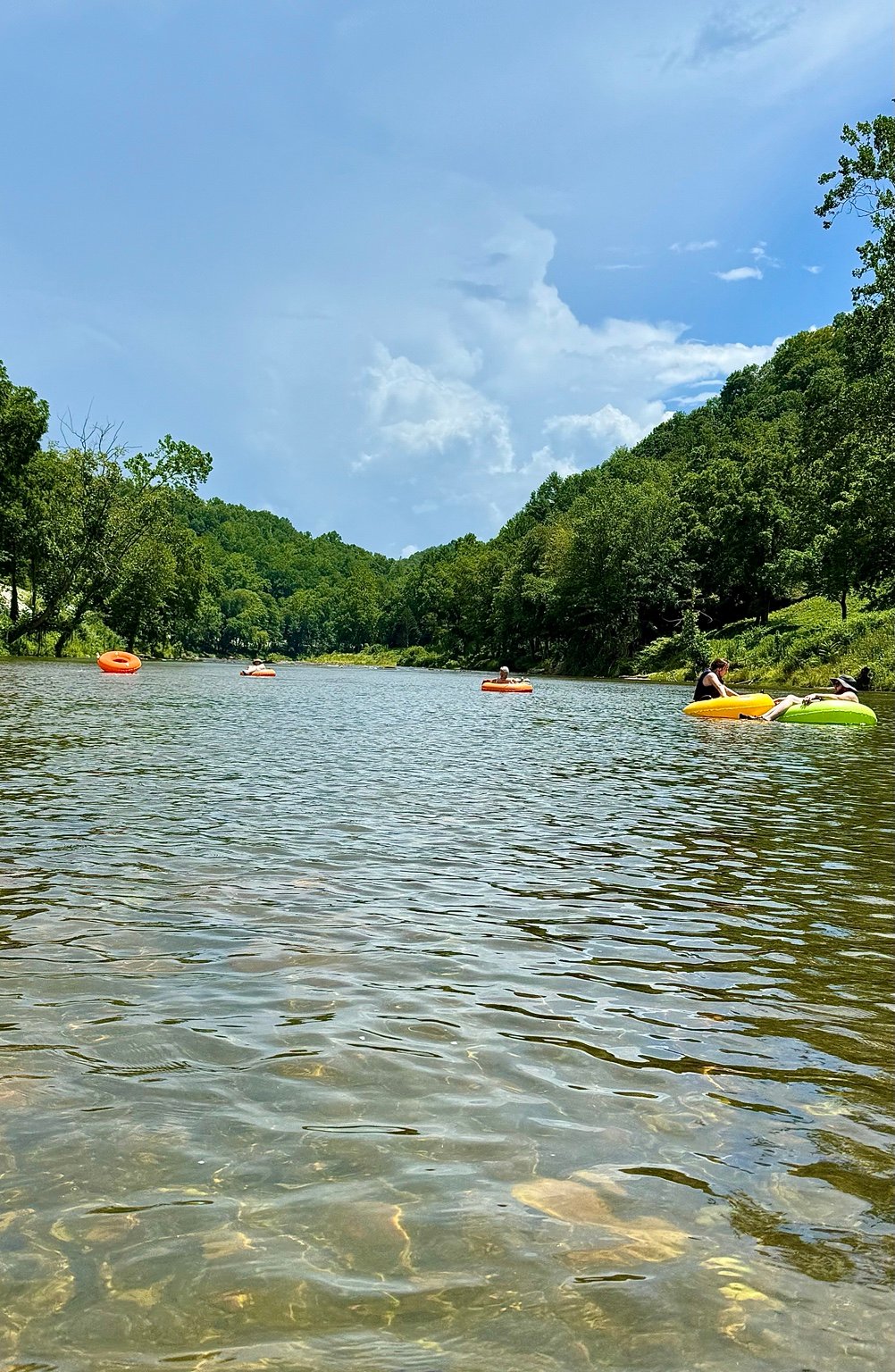Scenic summer view of guests tubing on the North Toe River in Western North Carolina